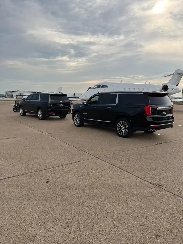 Black chauffeur SUVs positioned beside private aircraft